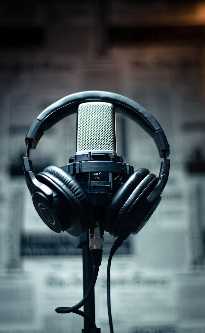 services-05 Microphone with headphones in a studio environment, perfect for sound recording and podcasting.
