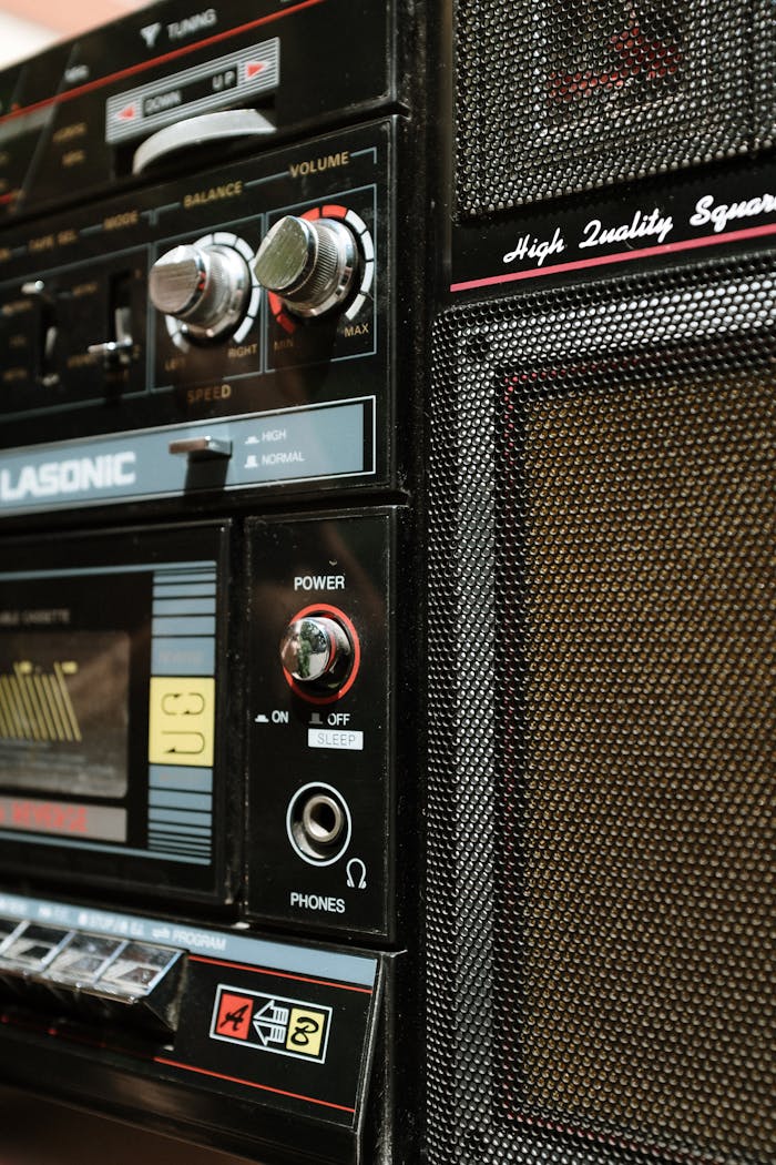 services-06 Vintage boombox showcasing classic design with close-up on controls and speaker.