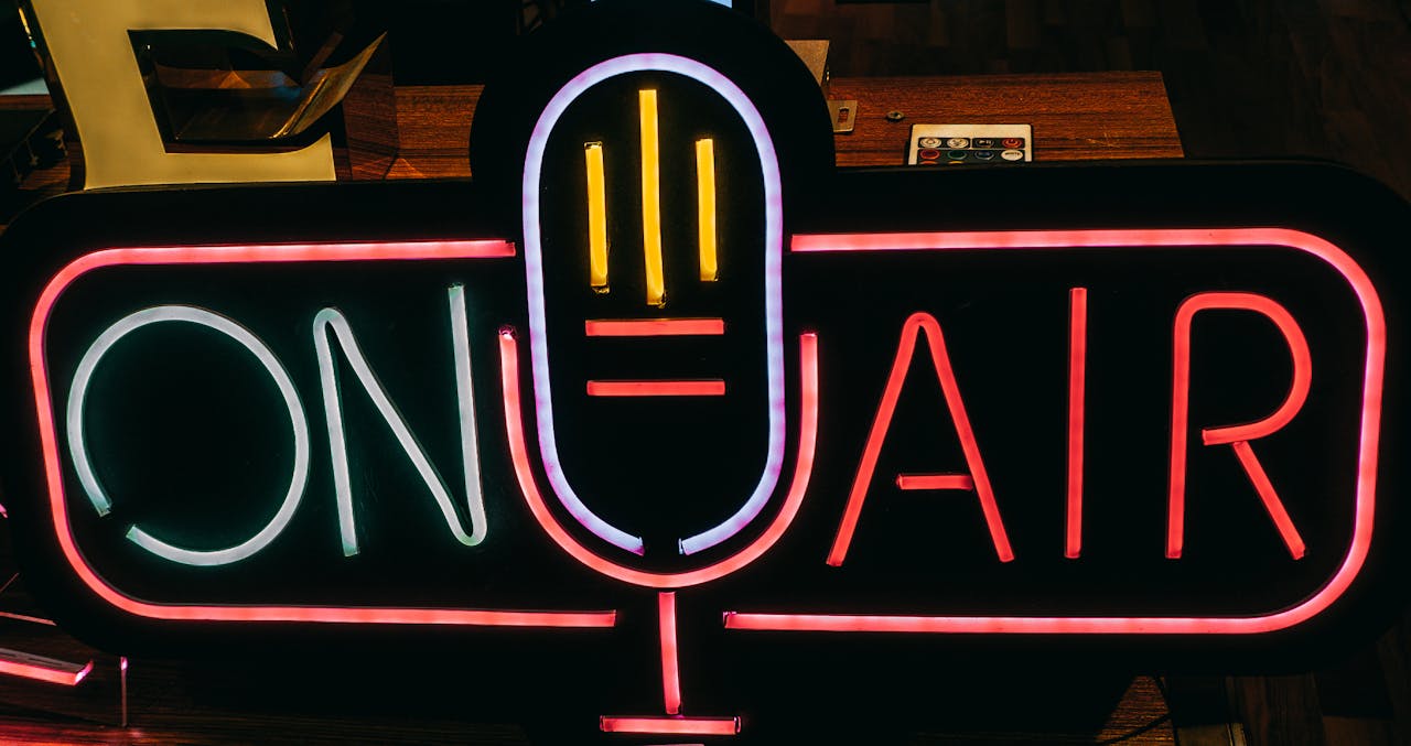 about-us Bright neon 'On Air' sign glowing in a dark studio, perfect for broadcasting themes.